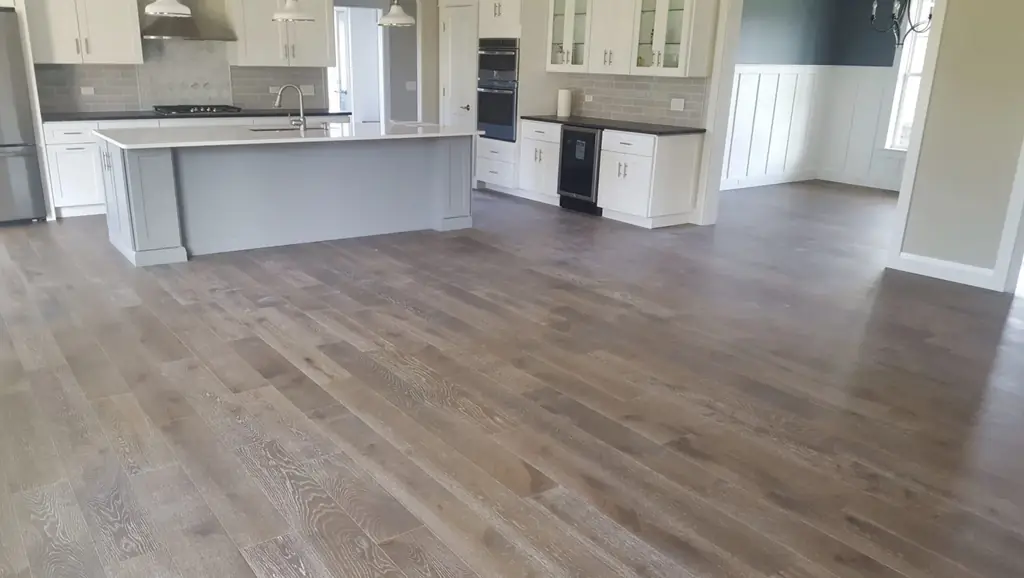 Luxury open plan kitchen with wide plank hardwood flooring