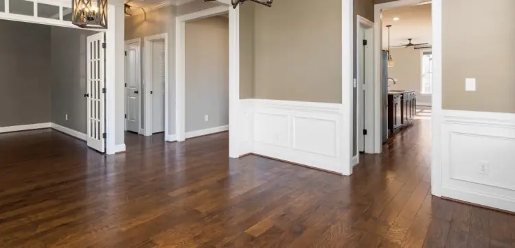 Hallway opening into a dining room, both in rich hardwood