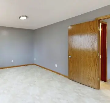 Empty bedroom freshly finished in light carpet
