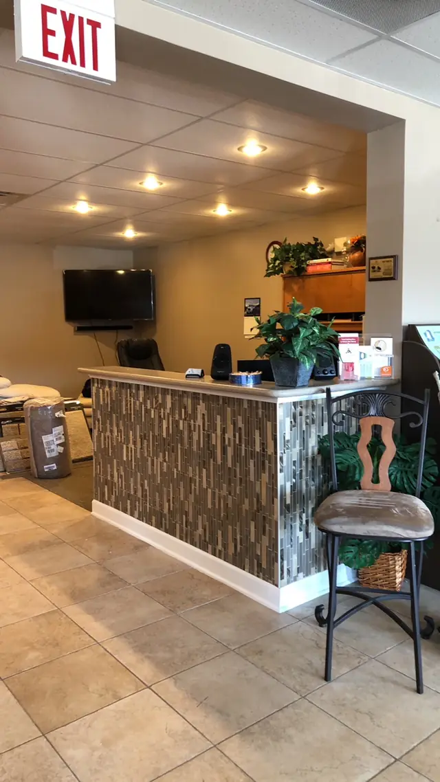 Inside the Cutting Edge showroom on Route 176, with carpet rolls and sample stacks beside the reception desk