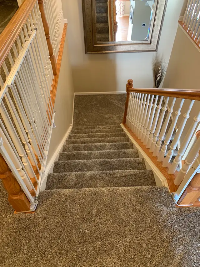 Carpeted stairs leading down from an upstairs landing